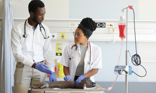 Two medical professionals treating a patient's leg