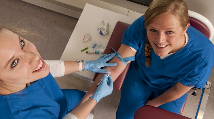 Nurse interacting with cheerful patient