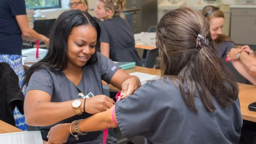 Healthcare worker applying tourniquet during training