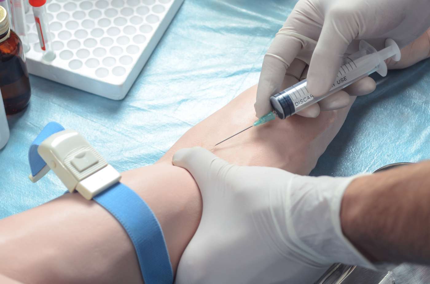 Medical professional taking blood sample