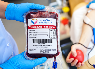 "Phlebotomist holding therapeutic blood collection bag"
