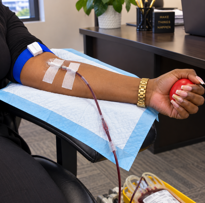 Patient squeezing stress ball during blood draw.